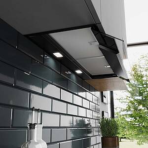 Man muss genau hinsehen, um sie zu entdecken: die flächenbündig installierte Designhaube mit sensor- und kochfeldbasierter, automatischer Anpassung der Lüfterleistung und viel Stauraum rechts & links durch ihr kompaktes Design